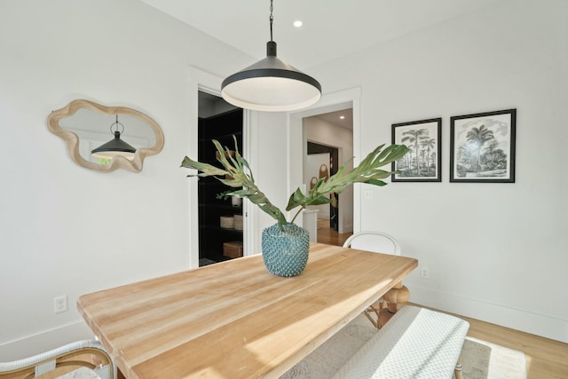 dining room featuring recessed lighting, baseboards, and wood finished floors