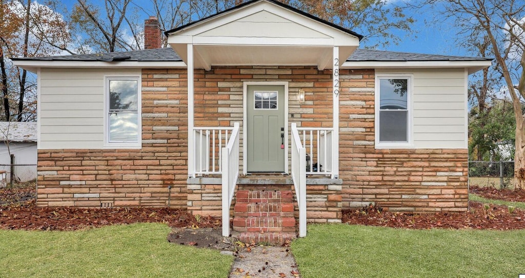 2829 Ranger Dr, North Charleston, SC 29405 - property entrance with a chimney, a shingled roof, and stone siding