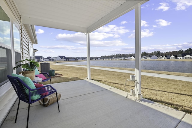 sunroom with a wealth of natural light and a water view