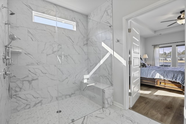 bathroom with plenty of natural light, ceiling fan, and a shower with shower door