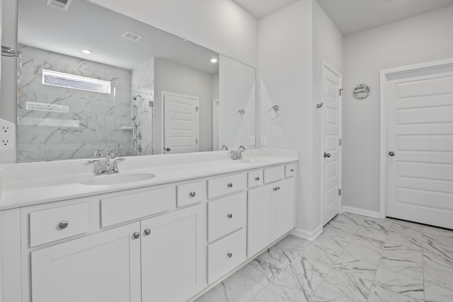 bathroom with vanity and tiled shower