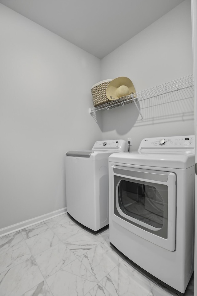 clothes washing area featuring separate washer and dryer