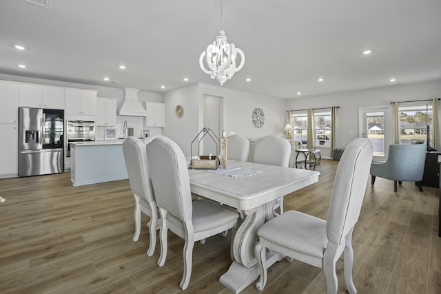 dining room with an inviting chandelier and light hardwood / wood-style floors