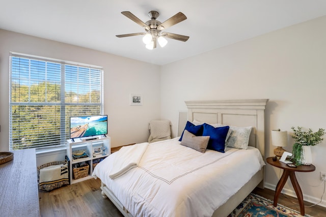 bedroom with hardwood / wood-style floors and ceiling fan