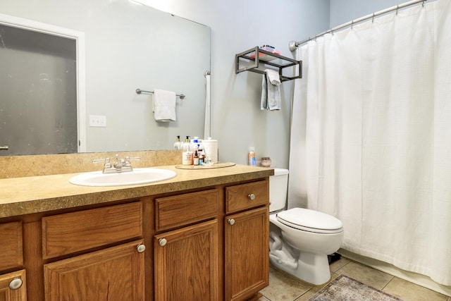 bathroom featuring toilet, vanity, and tile patterned flooring