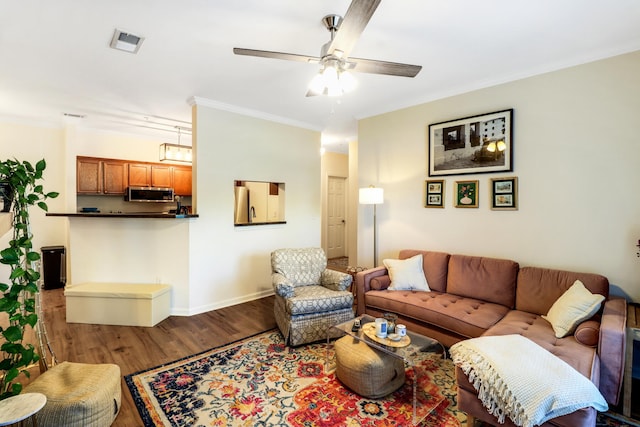 living room featuring crown molding, hardwood / wood-style floors, and ceiling fan