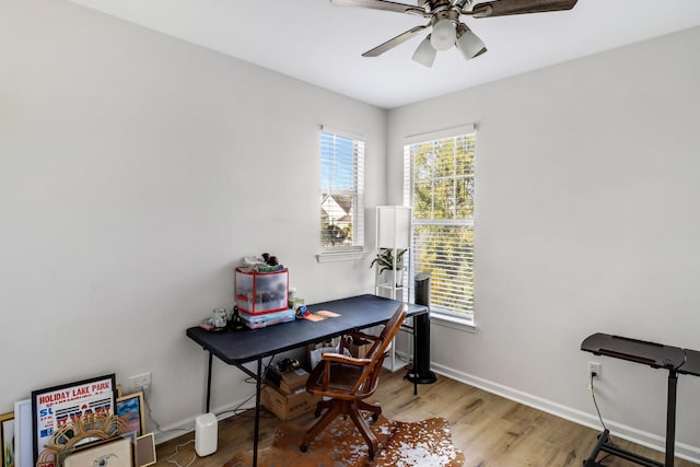 home office with hardwood / wood-style floors and ceiling fan