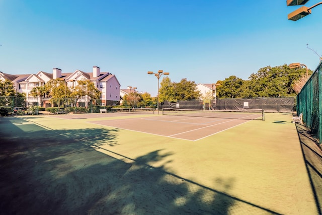 view of tennis court featuring basketball court