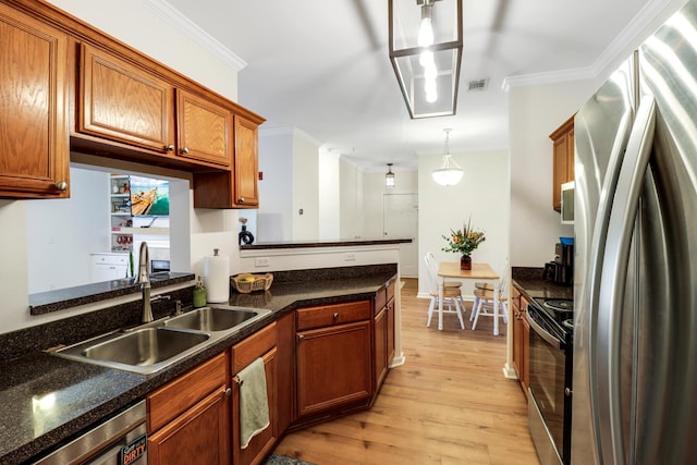 kitchen featuring stainless steel appliances, sink, crown molding, pendant lighting, and light hardwood / wood-style floors