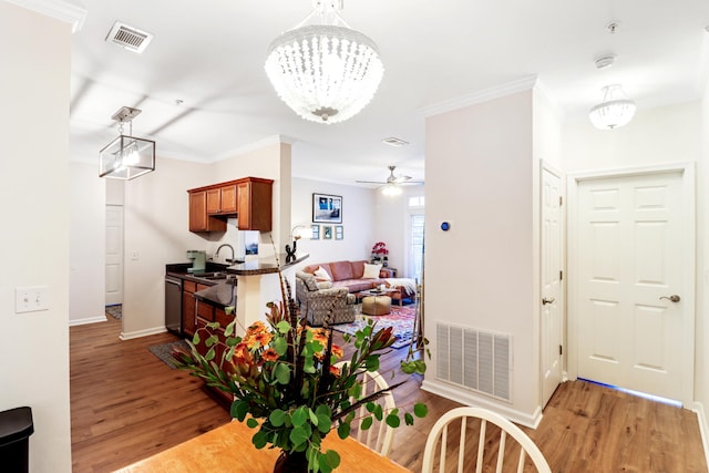 dining space with light hardwood / wood-style flooring and ornamental molding