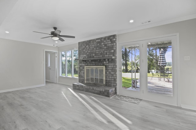 unfurnished living room with ornamental molding, a fireplace, and light wood-type flooring