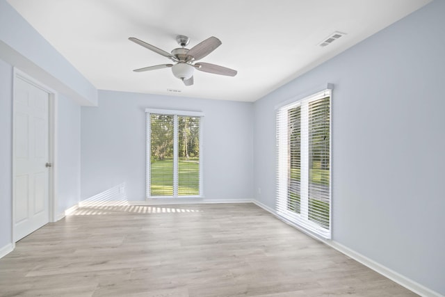 empty room featuring ceiling fan and light hardwood / wood-style flooring