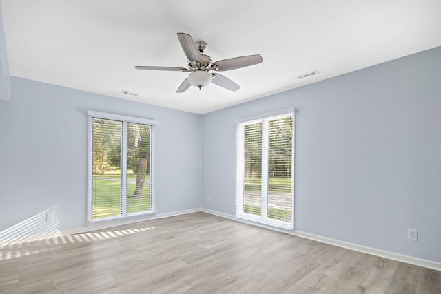 spare room featuring light hardwood / wood-style flooring and ceiling fan