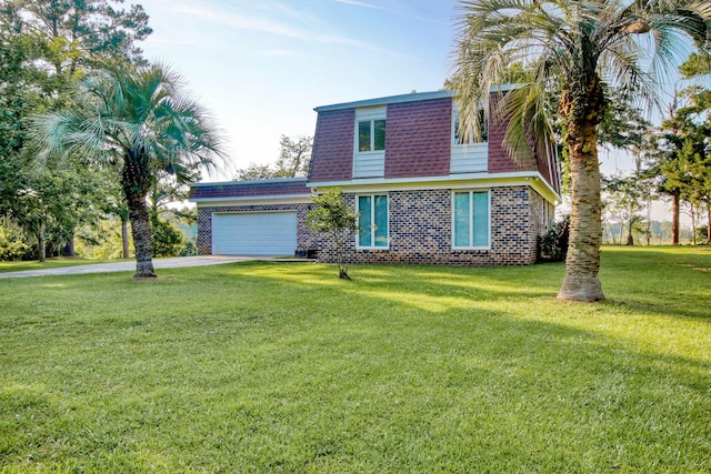 view of front facade with a garage and a front lawn