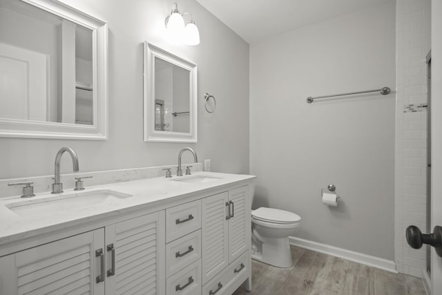 bathroom featuring wood-type flooring, vanity, and toilet