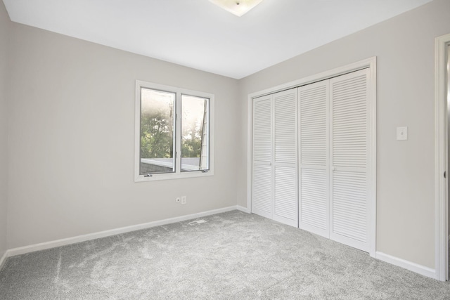 unfurnished bedroom with carpet floors and a closet