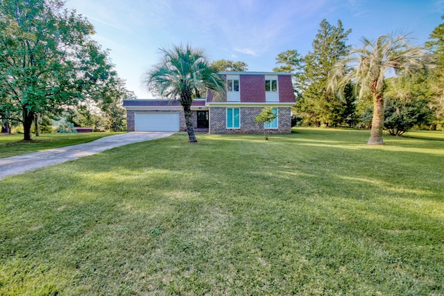 view of front of home with a garage and a front lawn