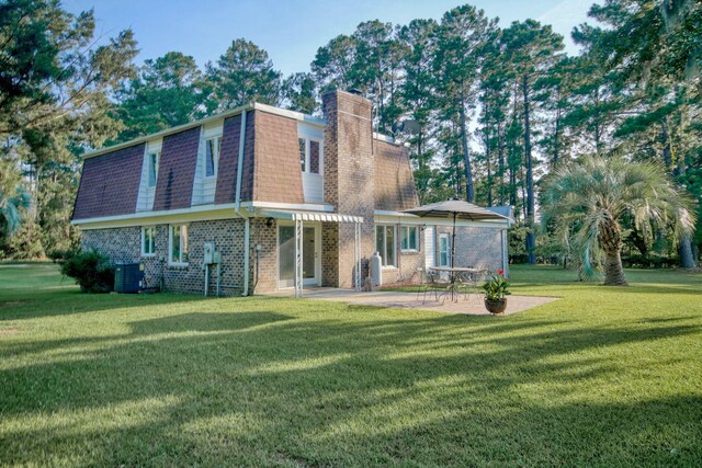 rear view of property with central AC unit, a patio area, and a lawn