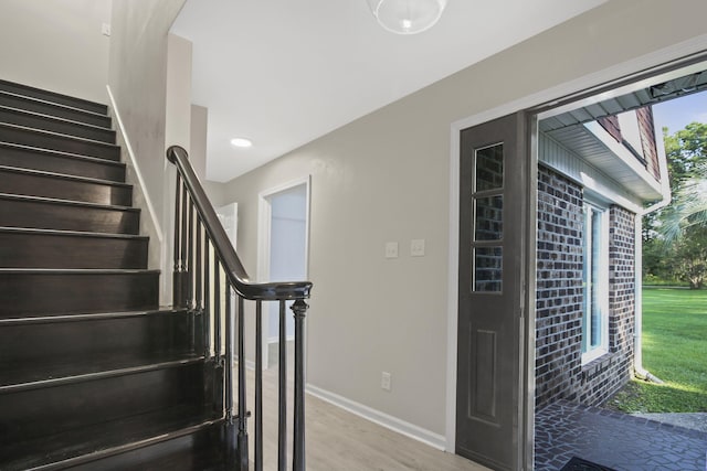 stairs with hardwood / wood-style floors