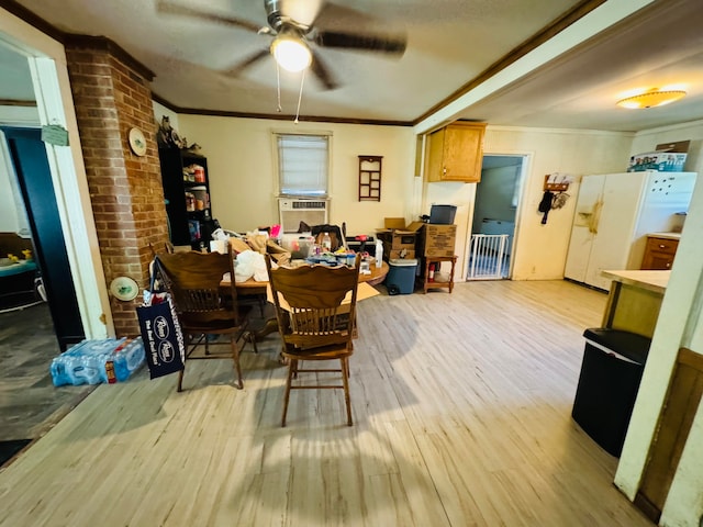 dining area featuring light hardwood / wood-style flooring, ceiling fan, crown molding, and brick wall