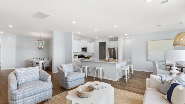 living area featuring visible vents, wood finished floors, and recessed lighting