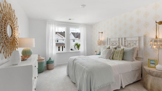 bedroom featuring light carpet, baseboards, and wallpapered walls