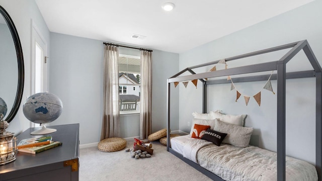 bedroom with carpet floors, visible vents, and baseboards