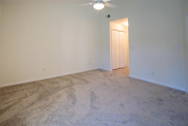 spare room featuring light carpet and ceiling fan