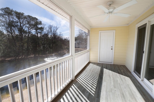 unfurnished sunroom featuring ceiling fan