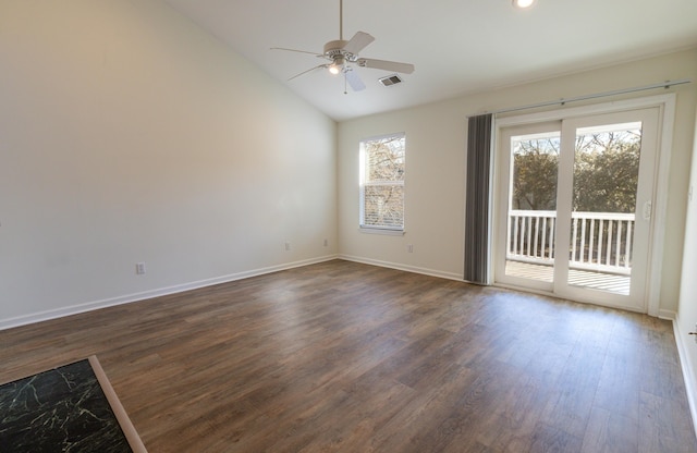 empty room with lofted ceiling, dark hardwood / wood-style floors, and a wealth of natural light