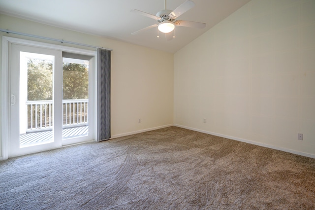 carpeted spare room with vaulted ceiling and ceiling fan