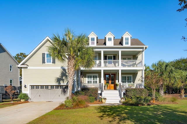 view of front of property with a balcony, driveway, a porch, french doors, and a garage