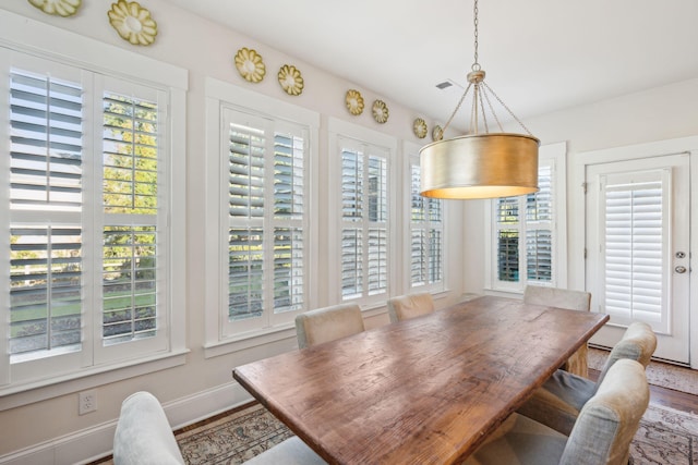 dining room featuring baseboards and wood finished floors