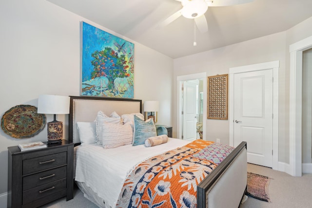 bedroom with connected bathroom, baseboards, light colored carpet, and ceiling fan