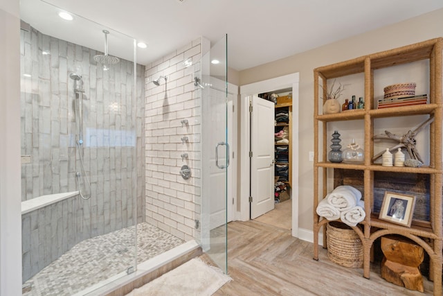 full bathroom featuring recessed lighting, a stall shower, and a walk in closet