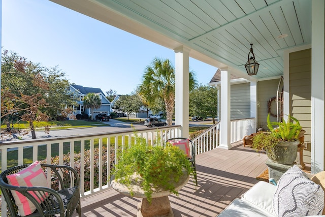 deck featuring covered porch and a residential view