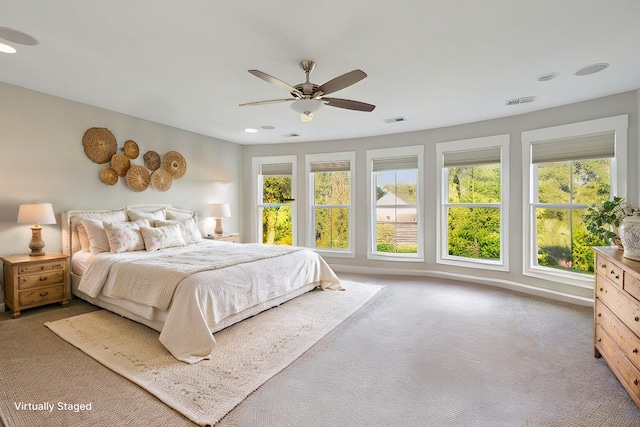 carpeted bedroom featuring recessed lighting, visible vents, baseboards, and a ceiling fan