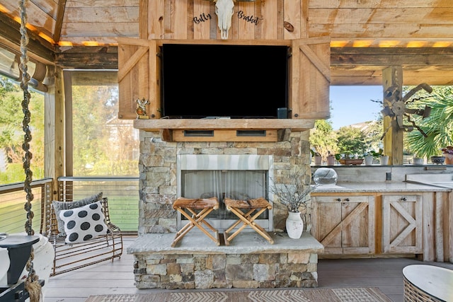 view of patio featuring an outdoor stone fireplace