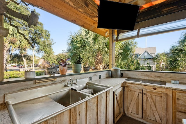 view of patio featuring a sink and an outdoor kitchen