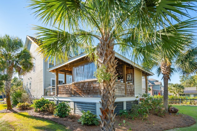 view of home's exterior with a yard and fence