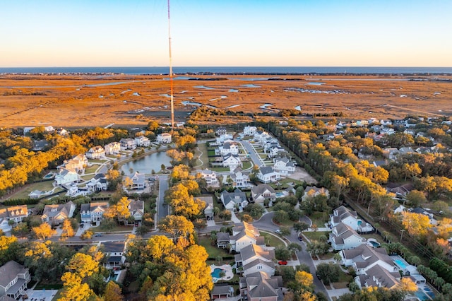 drone / aerial view featuring a residential view and a water view