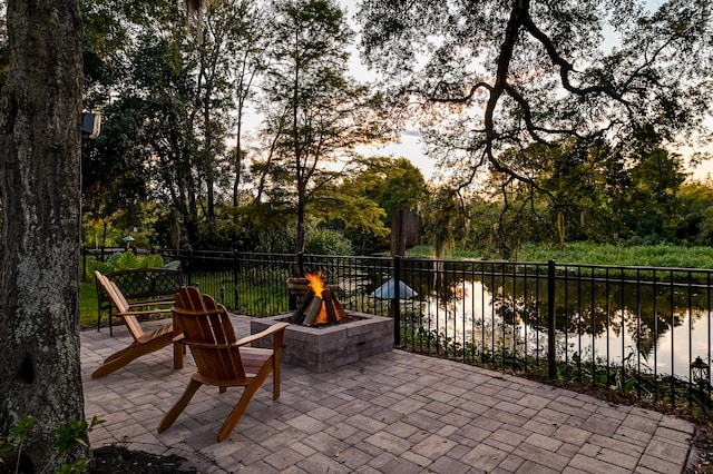 view of patio / terrace with a water view and a fire pit