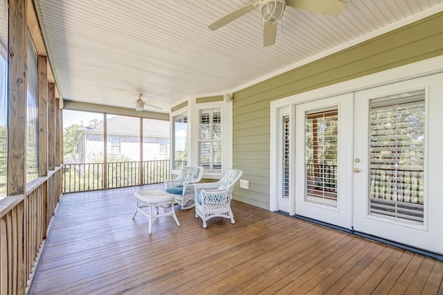 sunroom / solarium featuring french doors and ceiling fan