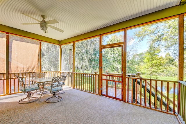 sunroom / solarium featuring ceiling fan