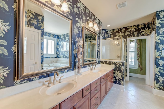 bathroom featuring tile patterned flooring, vanity, and a bath