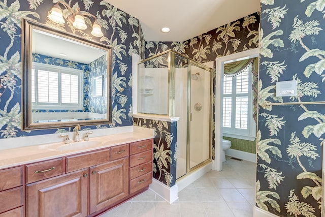 bathroom featuring plenty of natural light, toilet, and a shower with door