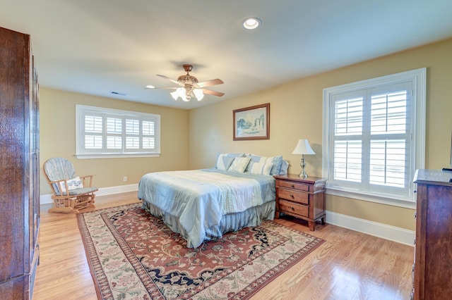 bedroom with ceiling fan and light wood-type flooring