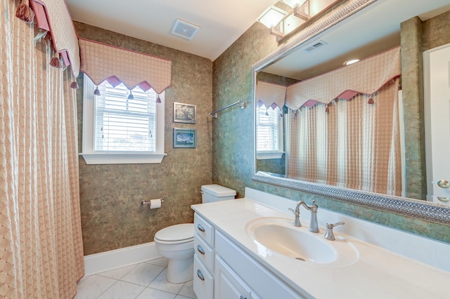 bathroom featuring vanity, toilet, tile patterned flooring, and a wealth of natural light