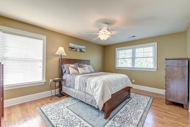 bedroom with light hardwood / wood-style floors and ceiling fan