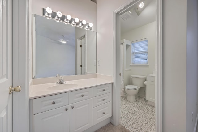 bathroom featuring toilet and vanity